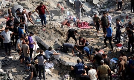 Palestinians work in the debris of buildings targeted by Israeli airstrikes in Jabalia refugee camp, northern Gaza, Nov 1, 2023